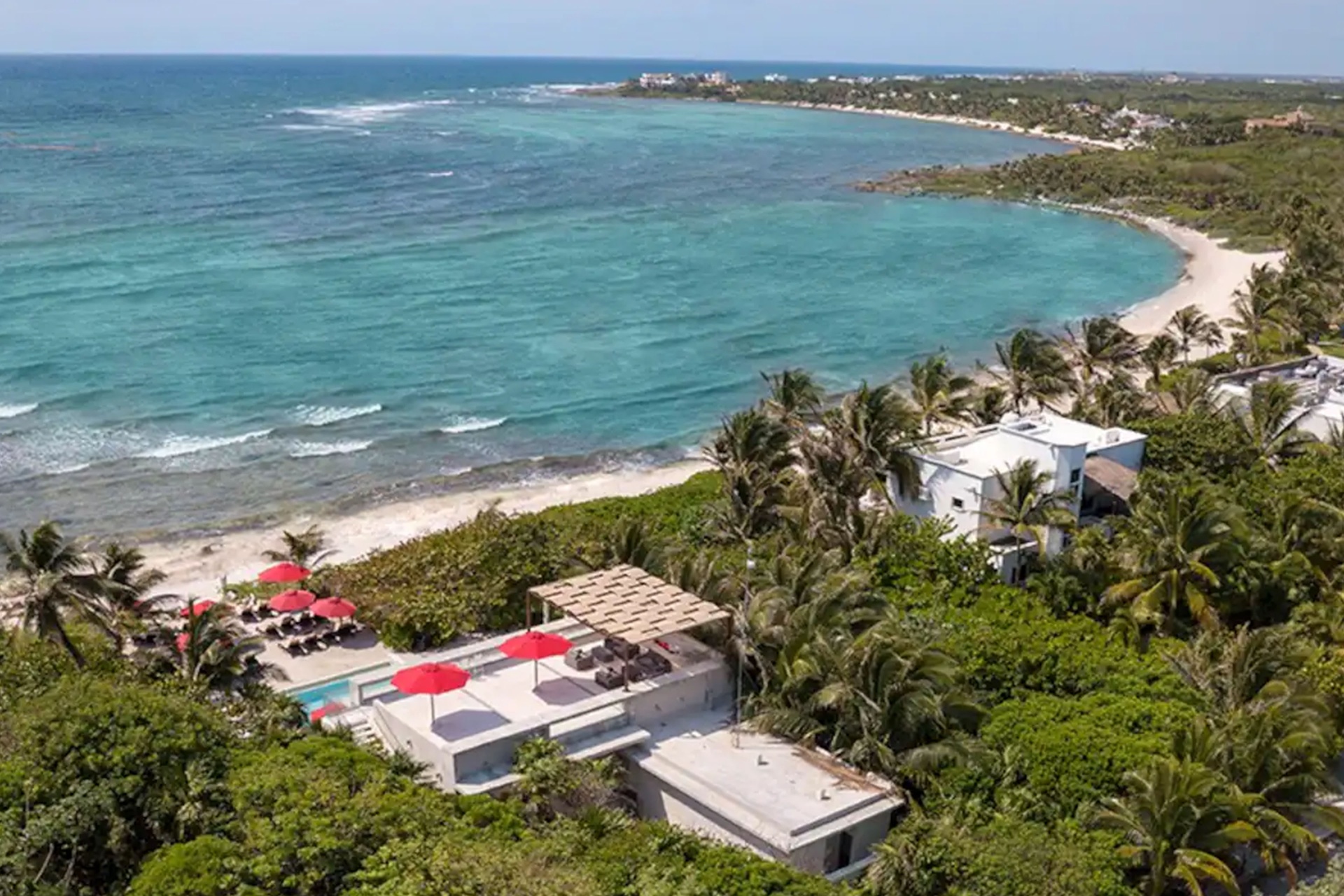 Calm turquoise water at Half Moon Bay in Akumal with palm-lined shore