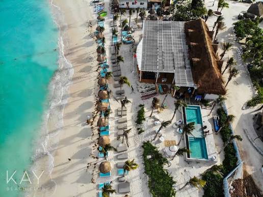 Aerial view of Kay Beach Club's palapa and pool on the Akumal shore