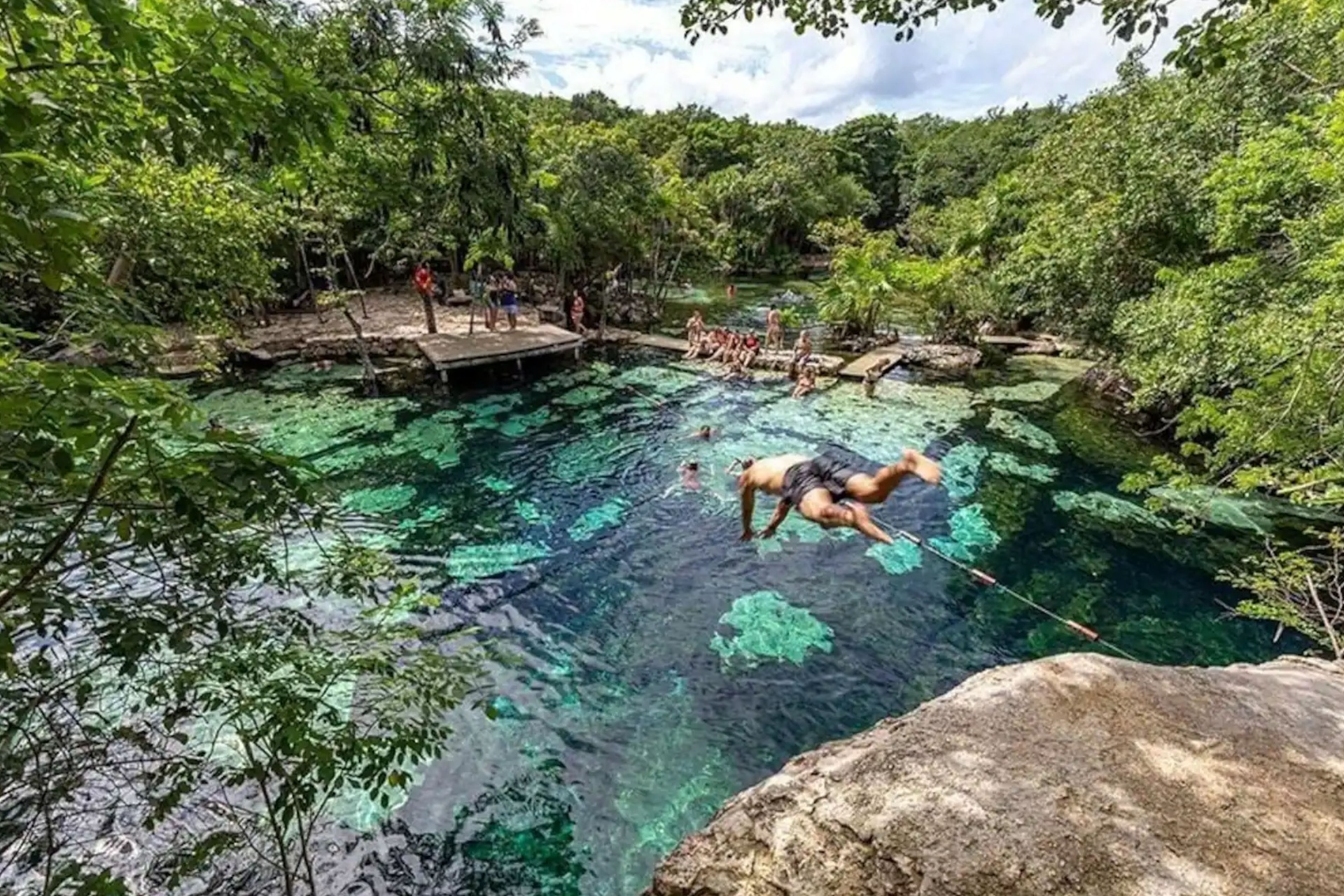 Shallow limestone edges and clear water at Cenote Azul near Akumal, safe for children
